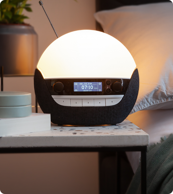 Round night light with digital display on a bedside table